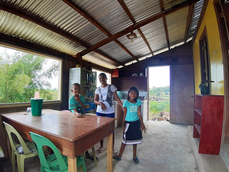 Mother and her children enjoying their new home in the Philippines.