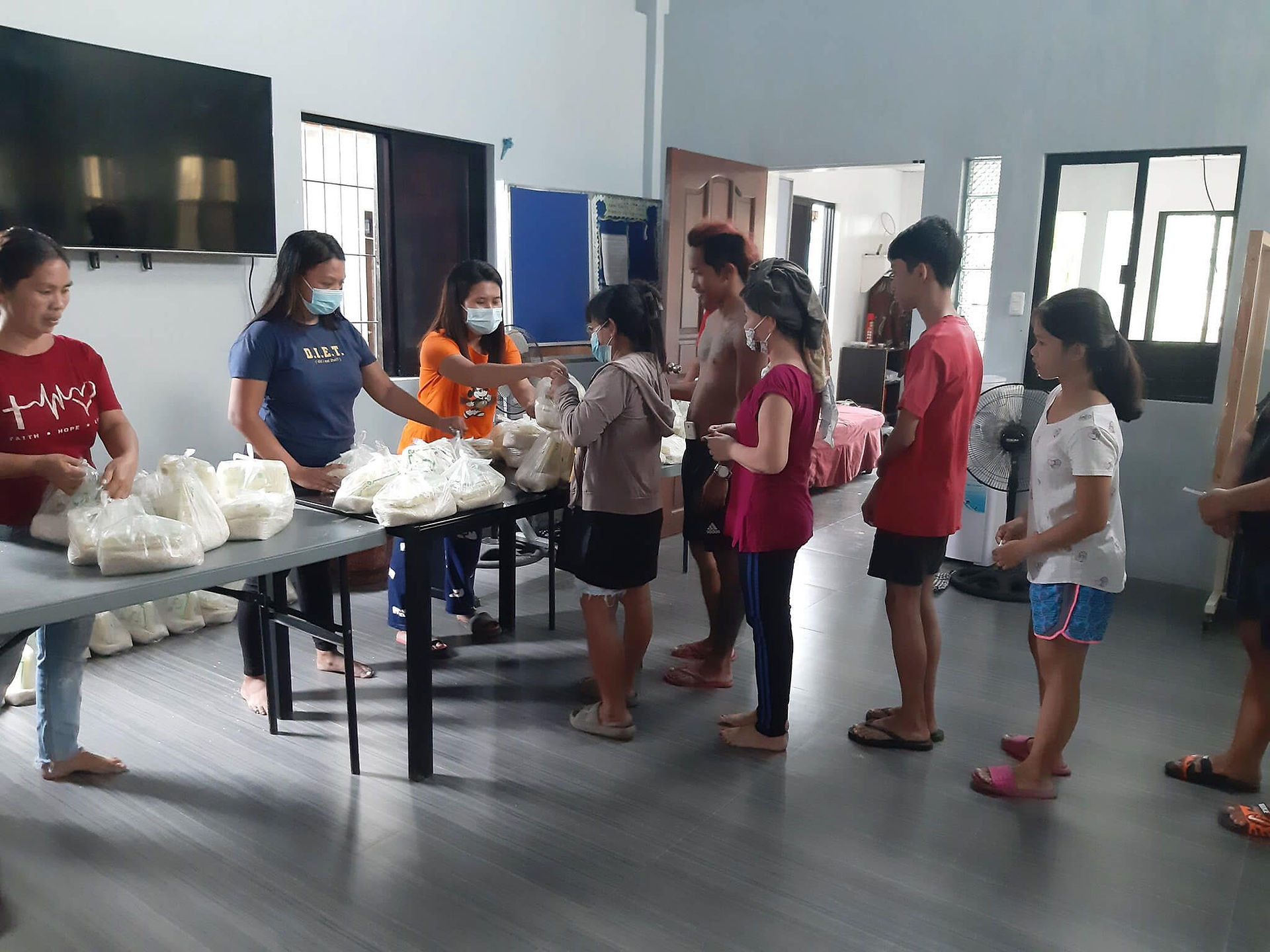 Abounding in Love employees distributing food to families in the Philippines