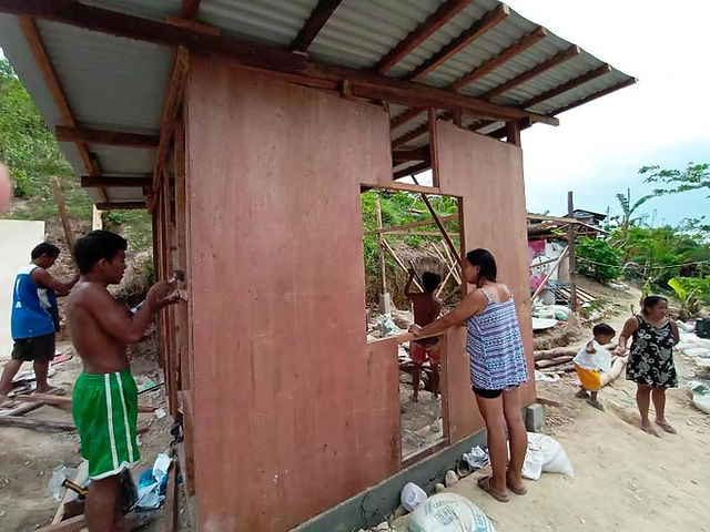 Abounding in Love employees installing new walls for a Filipino family in the Philippines.