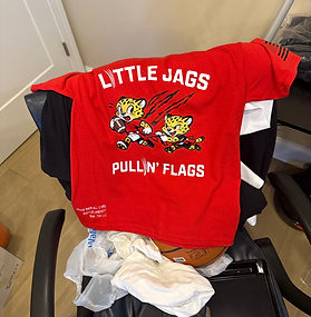 little Jags HTV custom youth football shirts laid flat showing team logo and name in heat transfer vinyl