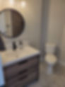Bathroom mirror, sink & toilet.
