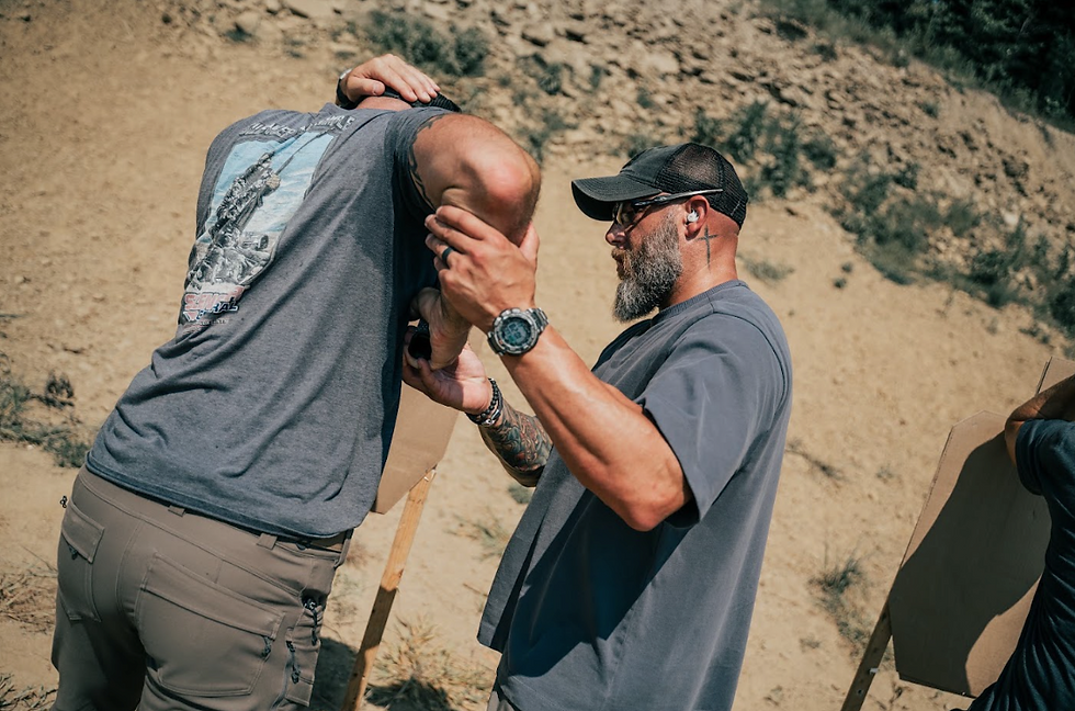 Providing hands-on instruction during a training exercise, helping a student refine his technique and develop a deeper understanding of the skills being taught.