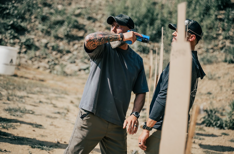 Demonstrating a defensive handgun technique to a student, reinforcing the importance of understanding when and why a technique works rather than simply memorizing the movements.