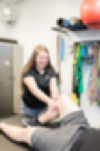 A performance physical therapist, Dr. Sieara Hinshaw of Outshine Physical Therapy and Fitness in Asheville, helps a patient with knee pain.