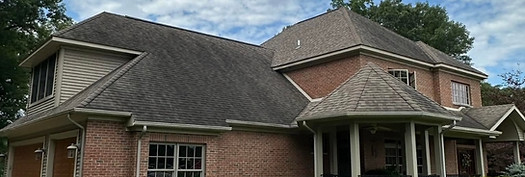 Roof of house before pressure washing service in Big Rapids