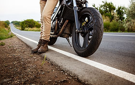 young-handsome-man-posing-near-his-motorbike-countryside-road.jpg