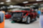Vehicle undergoing front-end repair in a garage