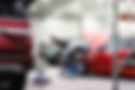 Cars being repaired inside a clean auto body shop