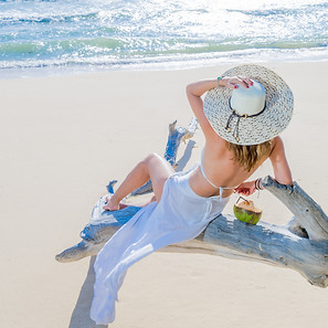 woman-sitting-on-a-tree-at-the-beach-202