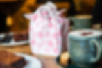 a small furoshiki-wrapped gift on a cafe table