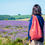 Thumbnail: Red furoshiki bag being carried  across a field