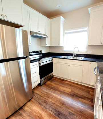 Modern kitchen features stainless steel appliances and granite countertops.