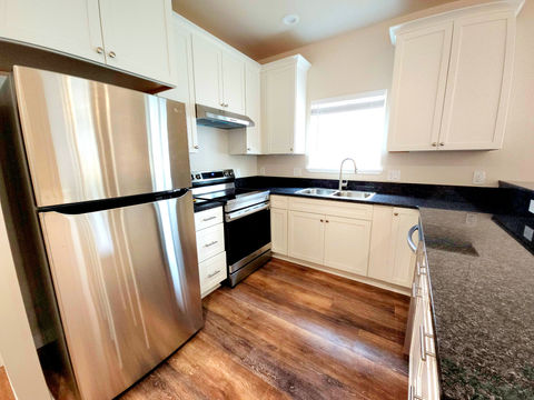 Modern kitchen features stainless steel appliances and granite countertops.