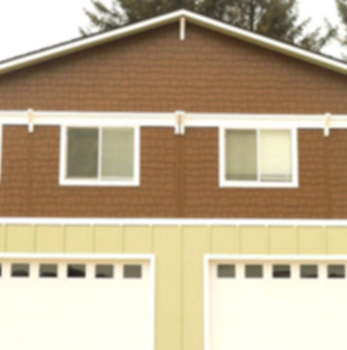 Two-unit house with double garages, brown and beige siding