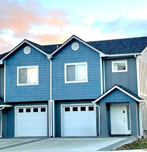 Blue duplex with attached garages, available now