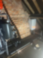 Heating system with tanks and pipes in an attic
