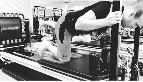 Client performing a leg rehabilitation exercise on Pilates equipment at Encore Pilates in Gainesville, FL. Focused on restoring strength, mobility, and balance with guided instruction in a supportive studio environment.