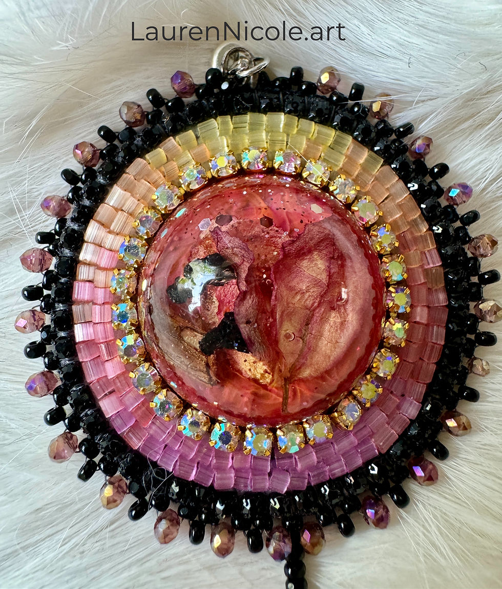 Beadwork is in pink, orange, yellow and edged in black.