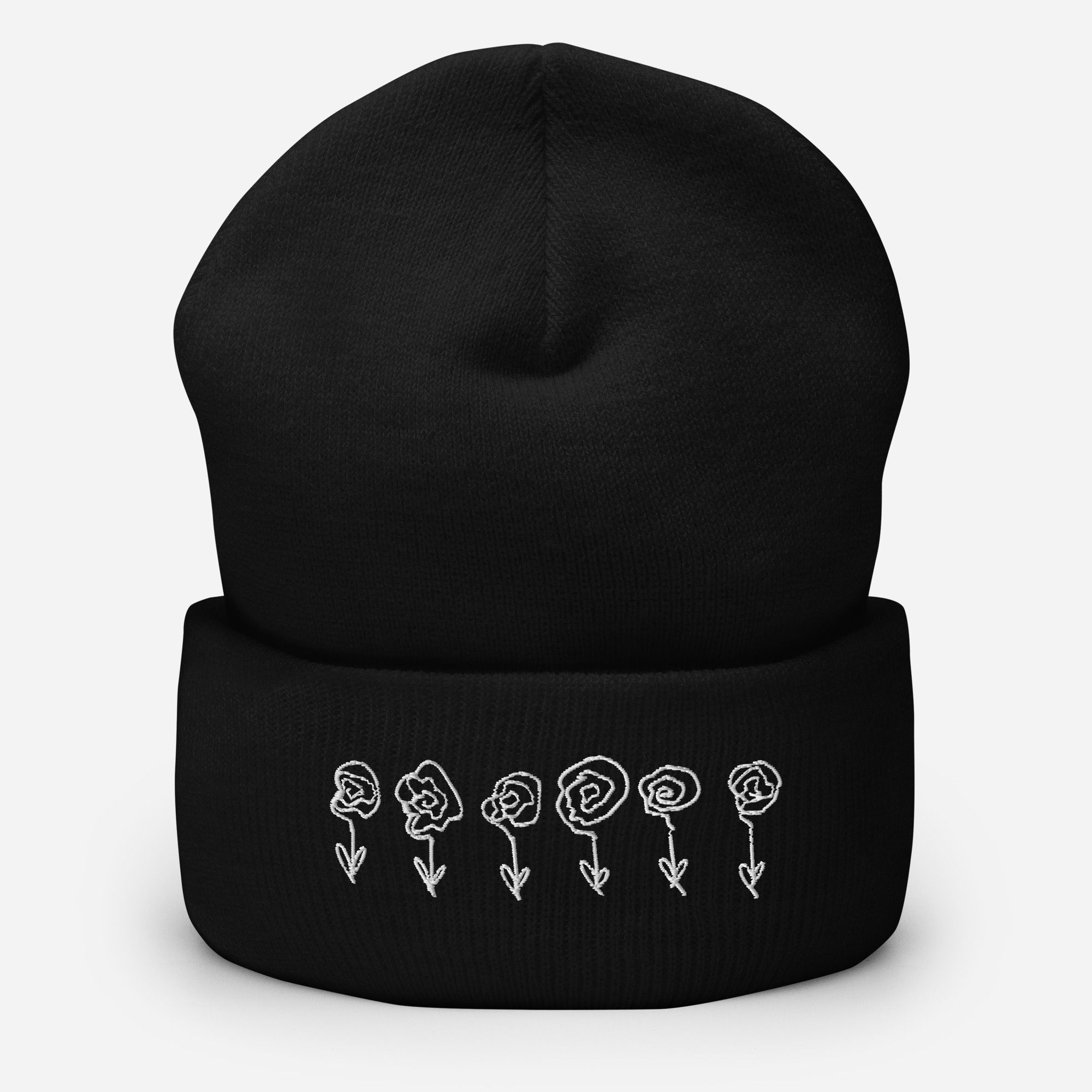 Lauren Nicole black cuffed beanie with a line of roses embroidered in white on front.
