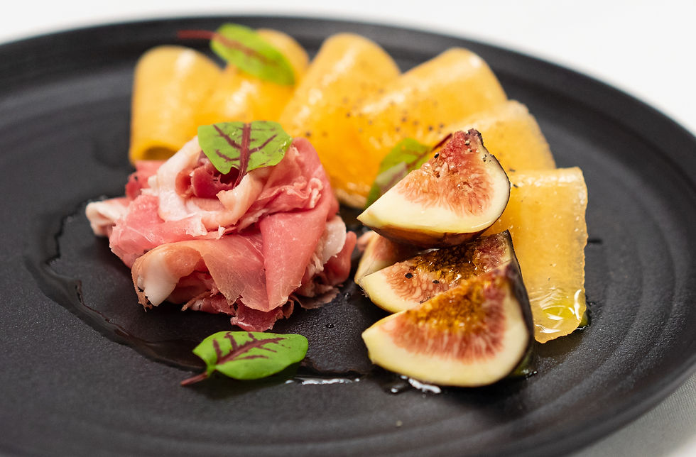 Prosciutto with fresh figs and melon drizzled with honey, a light grazing plate for a supper club menu