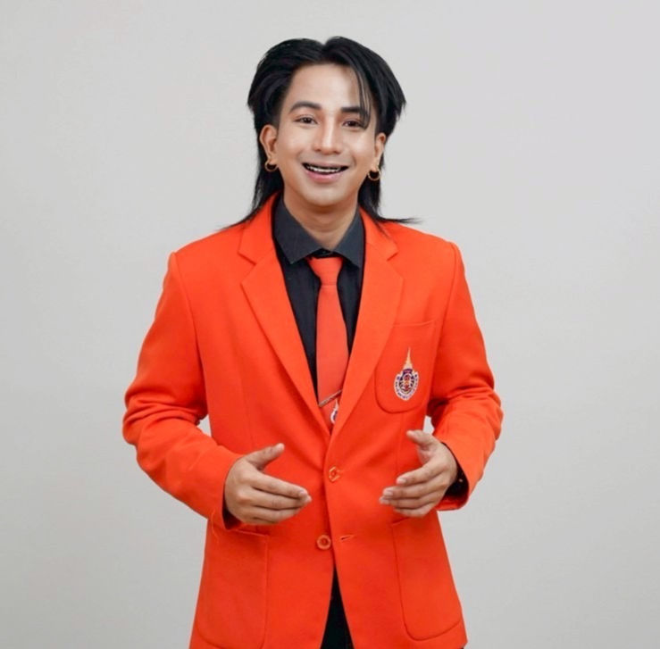 Smiling person in orange blazer and black tie