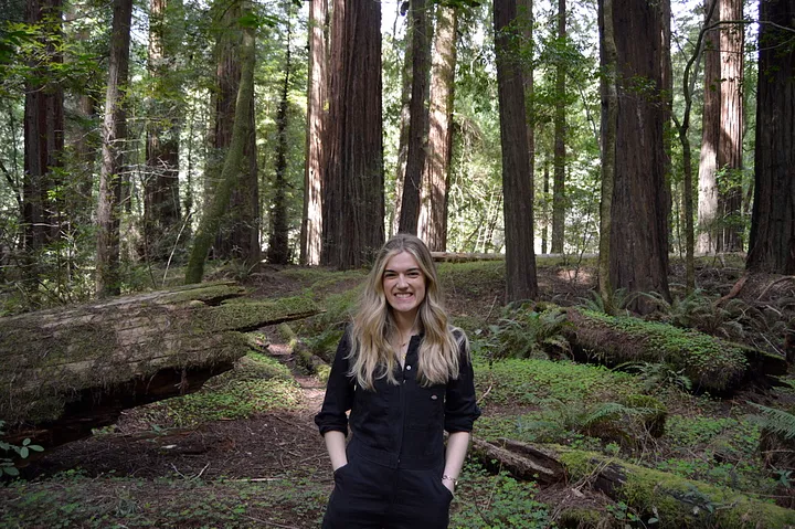 Standing in front of redwood trees in California