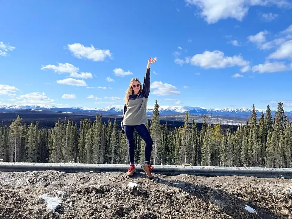 Posing on a dirty snow bank along the Alcan highway