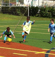 Alba FC youth soccer players in action during recreational match on Bronx school turf fiel