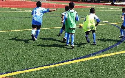 Recreational Soccer for Kids Bronx, young players chasing the ball with energy at Alba Soc