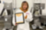 Maggie, Red Dog Blue Kat’s microbiologist, proudly displaying the company’s HACCP food safety certification
