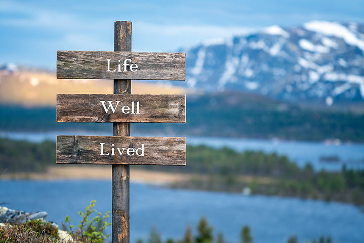 landscape of a lake and mountains with a sign post