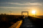 Photograph of sunset at the Bazaly lookout over Ostrava, dominated by a giant frame.