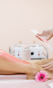 master-applies-pink-depilatory-wax-young-woman-s-leg-hair-removal.jpg