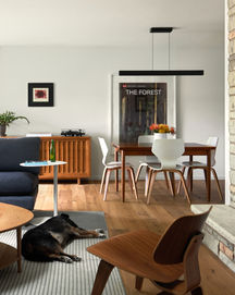 a poster of the forest hangs above a dining table