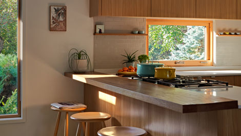 a kitchen with stools and pots on the stove