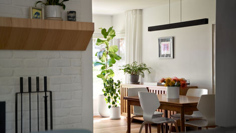 a dining room table with a vase of flowers on it