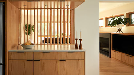 a kitchen with wooden cabinets and candles on the counter