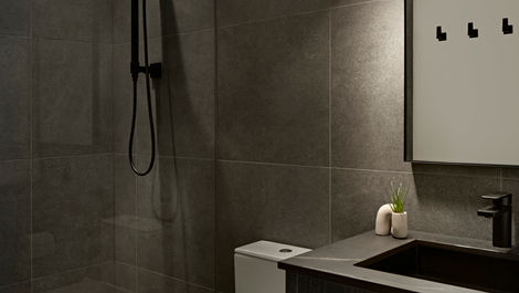 a bathroom with dark tile