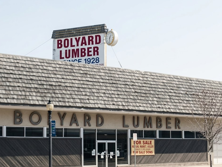 Vintage Bolyard Lumber storefront building with outdoor clock and signage