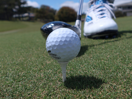 Close-up of a golf ball on a tee with a club ready to strike — capturing the moment before impact, where consistent contact begins.
