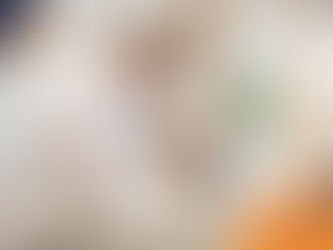 A couple in white shirts sits on the floor petting a happy Labrador in a bright room with plants. Wilsons Health logo is visible.