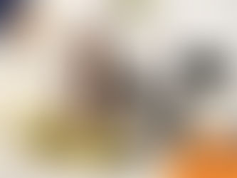 Woman smiling on a couch, holding a mug, next to a black and white dog. Cozy living room with green zigzag pillow. Wilsons Health logo.