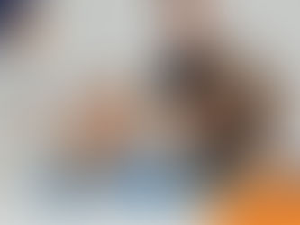 Woman in blue sweater takes a selfie while smiling. A man holds a gray dog, smiling at her. Logo at the bottom right reads "Wilson's Health."