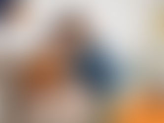 Woman kisses a girl's forehead while sitting on a couch with a Shih Tzu dog. The girl holds a book. Wilsons Health logo visible. Cozy setting.