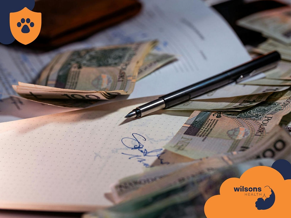 Scattered banknotes, a pen, and paperwork on a desk. Notable signature on paper, with Wilsons Health logo in lower right corner. Warm light.