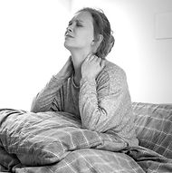 tired-sick-woman-on-bed-touching-her-neck-suffering-from-pain_edited.jpg