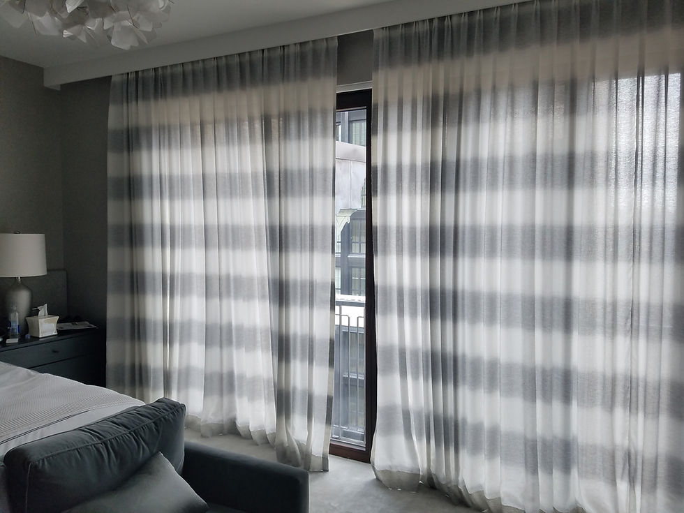 Elegant motorized roller curtains with a subtle striped pattern enhance the modern aesthetic of this cozy bedroom.