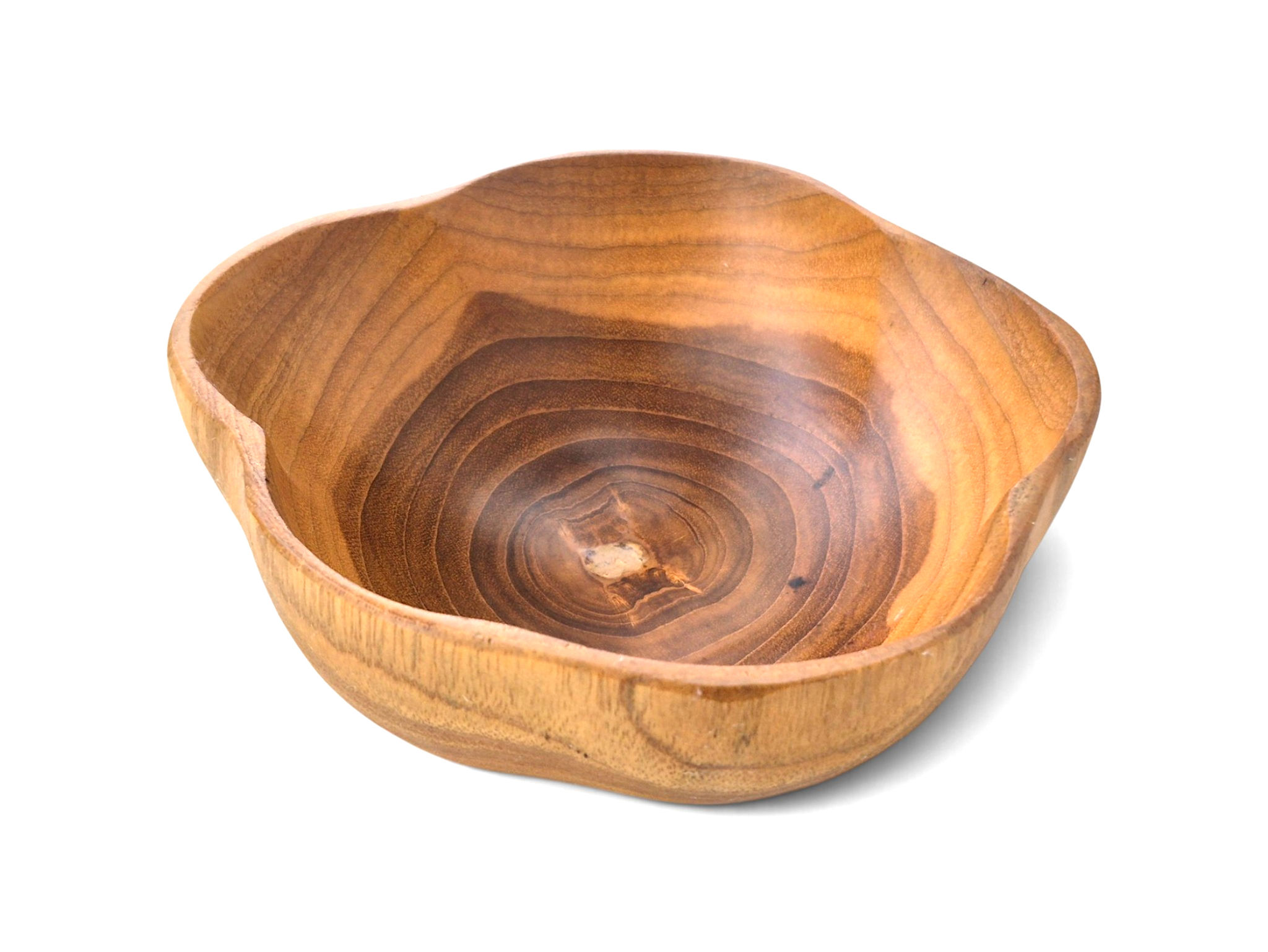 Front view of a hand-carved teakwood bowl with a softly curved natural edge