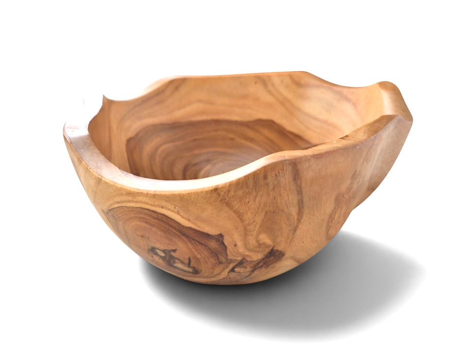Front view of a hand-carved teakwood bowl with a pronounced wavy edge