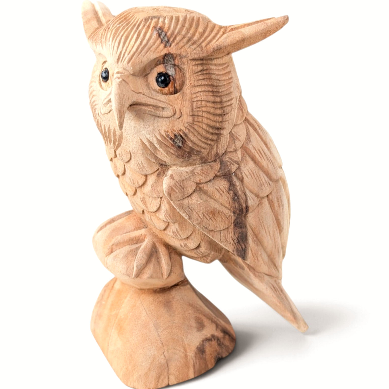 Hand-carved teakwood owl figurine perched on a sculpted wooden branch